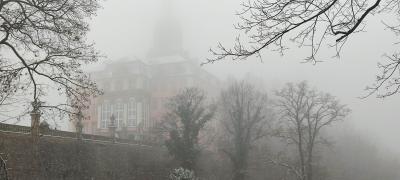 Zamek w Książu skąpany we mgle.